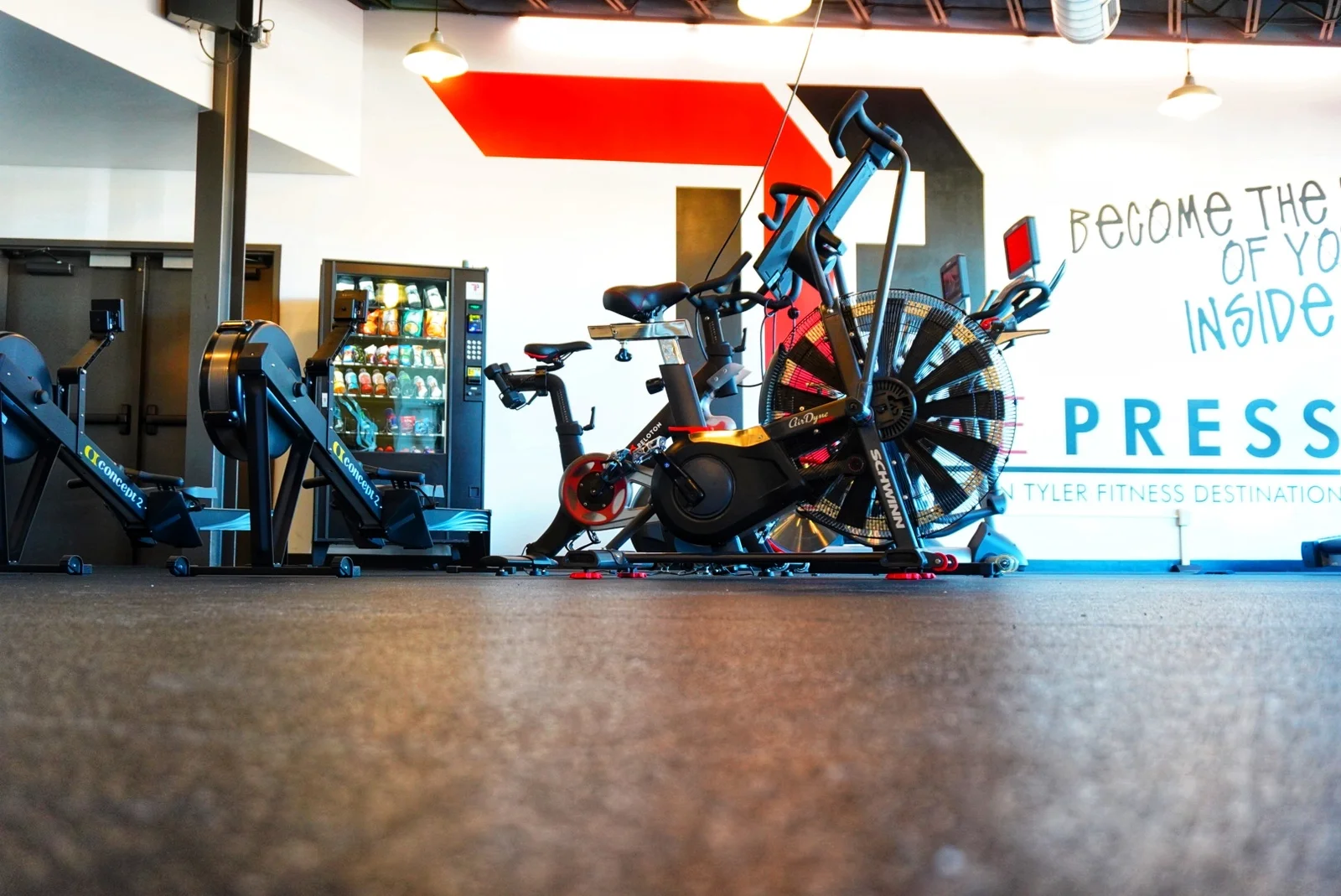 Cardio deck featuring Concept2 rowers, Schwinn Airdyne bikes, and Peloton